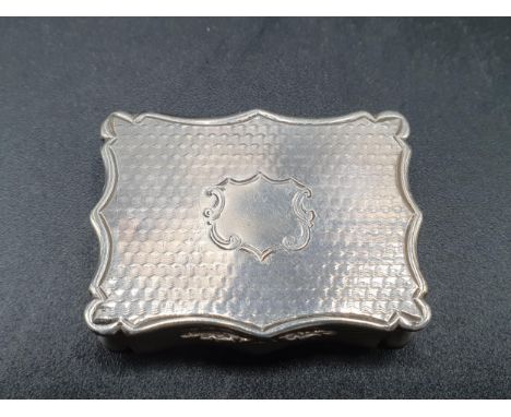 A Victorian silver rectangular Vinaigrette with engine turning and vacant cartouche, scroll pierced grille, Birmingham 1842, 