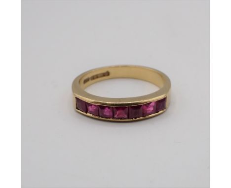 A Ruby half Eternity Ring channel-set baguettes in 18ct gold, ring size L 1/2, approx 3.70gms 