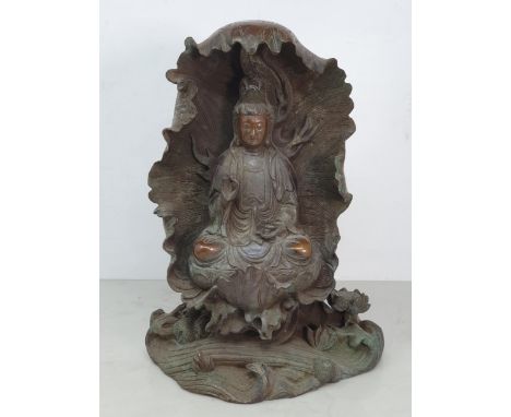 A bronze Figure of a Seated Guan Yin Buddha in Lotus Leaf, 10.5"High. 