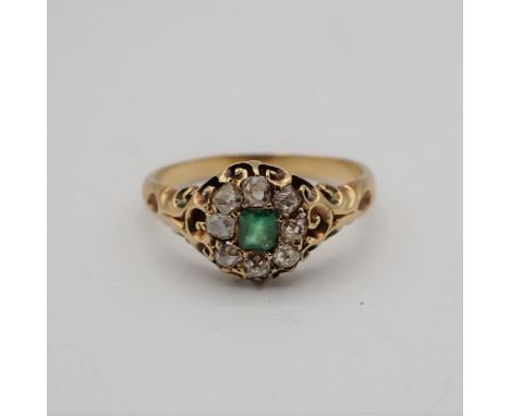 An Emerald and Diamond Cluster Ring pavé-set step-cut emerald within a frame of old-cut diamonds in sculpted mount, ring size