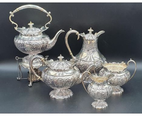 A George V silver five piece Tea and Coffee Service with floral embossing, rococo cartouches engraved initials, Sheffield 191