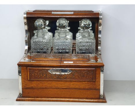 A George V silver mounted oak Tantalus/Games Compendium with presentation inscription "Presented to Harry Preedy Esq from his