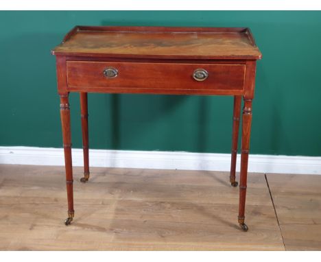 A Regency mahogany Sidetable, the galleried moulded top above a frieze drawer, on slender ring turned legs and brass casters.
