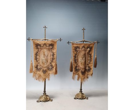 A pair of 19th Century Brass Table Pole Screens with a cruciform top and hanging Tapestry on cast shaped bases 1ft 10in High.
