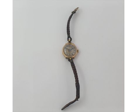 A lady's 9ct gold cased Wristwatch the two coloured dial with engine turning and arabic numerals, case width approx 22mm, mon