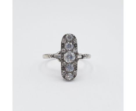 An early 20th Century Diamond five stone Ring pavé-set a column of graduated old-cut stones between smaller stones in white g