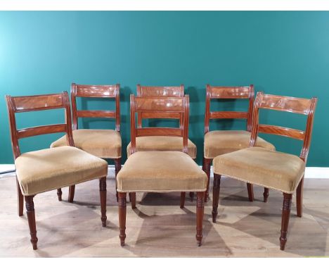 A set of six 19th Century mahogany Dining Chairs with scrolled bar backs, stuff-over seats on ring turned front supports 