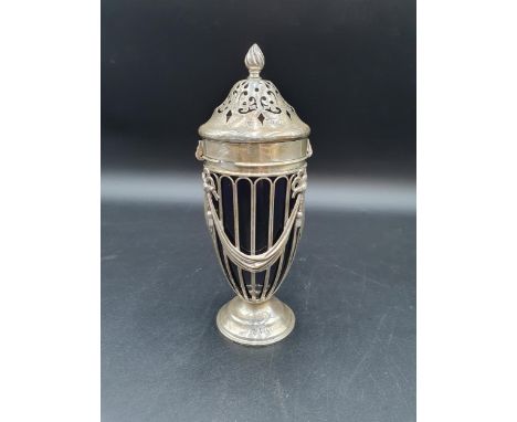 An Edward VII silver Sugar Caster of urn shape decorated ribbons and swags, spiral finial, blue glass liner, London 1903, mak