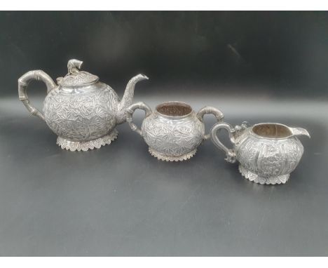 A Chinese silver three piece Tea Service of globular form, the teapot and sugar bowl with all over bamboo design and simulate