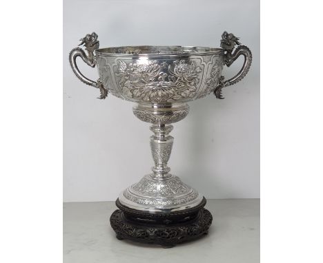 An Impressive Chinese Silver Presentation Trophy with ornate flowering shrub and insect decoration, ornate dragon handles, in