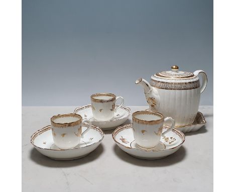 A Caughley barrel shaped Teapot with gilt decoration, with a Teapot Stand and three Caughley Cups and Saucers with gilt flora