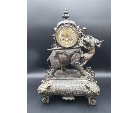 A 19th Century Mantel Clock with drum dial having enamel numerals on gilt metal ground, two train movement striking on single