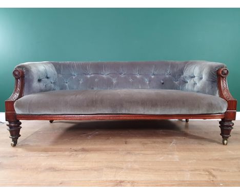A 19th Century carved walnut Salon Chesterfield, the button down back and stuff over seat on taper turned legs and casters. 5