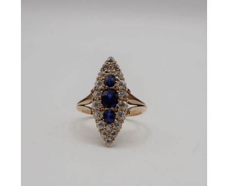 A Sapphire and Diamond Cluster Ring the marquise shaped plaque pavé-set three graduated round sapphires within a frame of old