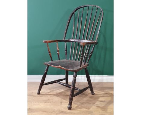 A 19th Century ash stick back Elbow Chair with early black paint remnants on turned supports united by H-stretcher 3ft 6in H 