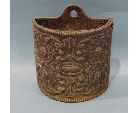 A wall-mounted half-round lead planter with embossed foliate decoration, 25cm high, 22cm wide. 