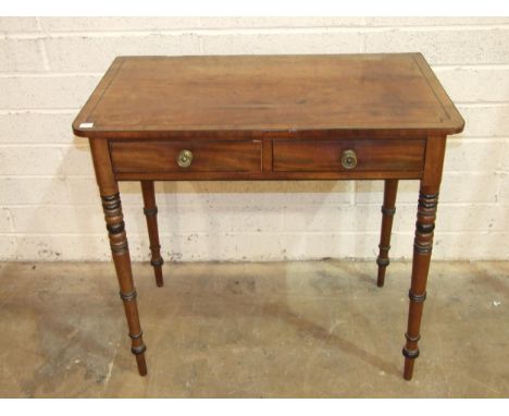 A George IV ebony inlaid mahogany two-drawer side table on ring-turned legs, 82cm wide, 48cm deep, 75cm high, (small patch of