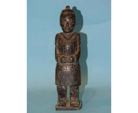 A carved stone figure of a Chinese warrior in the style of a Terracotta Army figure, 25cm high. 