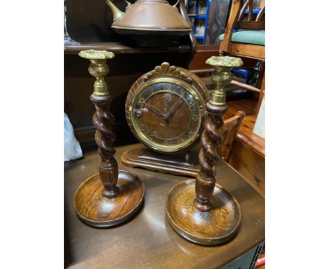 An oak cased mantel clock together with a pair of Barley twist and brass topped candle sticks. Also together with a Copper an