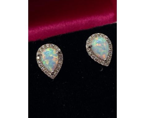 A Pair of 925 silver cz and pear shaped opal stud earrings on silver posts. Comes with presentation box. 