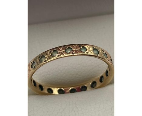 A Ladies 9ct gold band ring set with gem stones. [Ring size K] [2 Grams] 