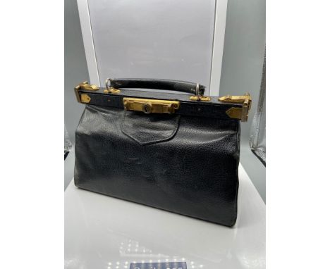A Vintage ladies clutch bag with brass mounts and lock. 