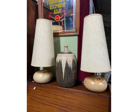 A Vintage stone ware flagon converted to a lamp base together with two studio pottery table lamps with canvas style shades. 