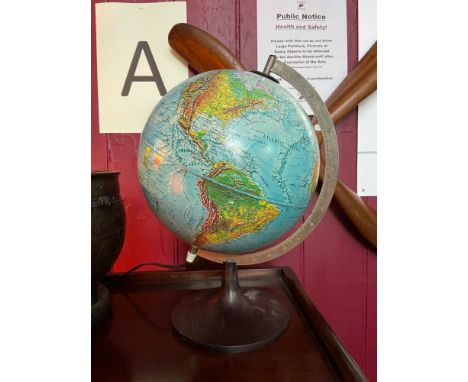 A vintage light up desk globe designed on a bakelite stand. [37cm in height] 