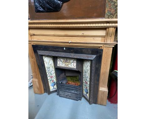 Antique cast iron and tile design fire insert together with a solid pine fire surround. 
