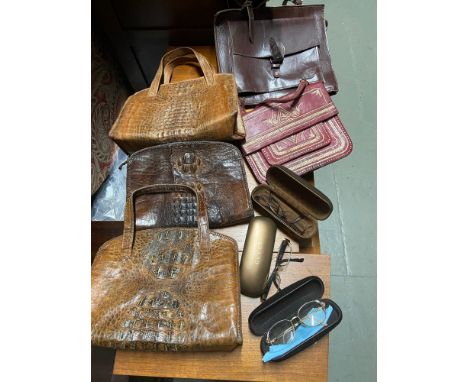 A Lot of vintage fashion accessories which include three crocodile leather hand bags, Three Gucci glasses and two other bags.