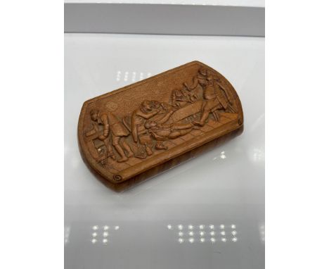 An 18th/ 19th century hand carved bur walnut tobacco/ snuff box. The lid is hand carved detailing various figures drinking. [