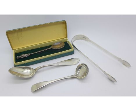 A pair of Georgian silver sugar bows, a Georgian silver sifting spoon, a silver spoon with a figural Bishop finial and one ot