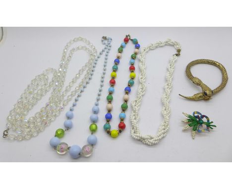 A snake bangle, four vintage bead necklaces and a brooch 