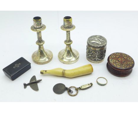A pair of small candlesticks, a snuff box, a pipe tamp, a circular pot with lid, a very small enamelled 'Baby' ring, etc., (m
