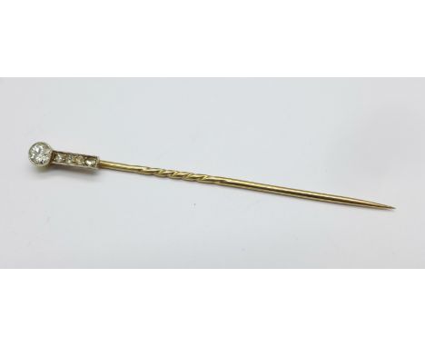 A yellow and white metal set diamond Art Deco stick pin, set with a brilliant cut diamond and four rose cut diamonds, (brilli