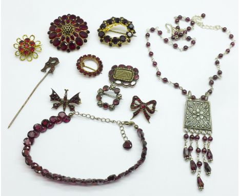 A collection of garnet set jewellery; a 19th Century mourning brooch, lacking pin, one stone a/f, glass a/f, six other brooch