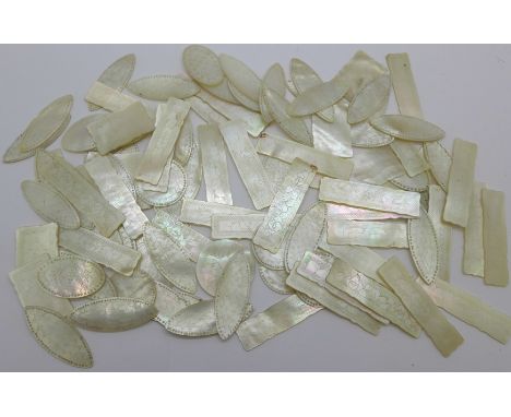 A collection of mother of pearl gaming tokens 