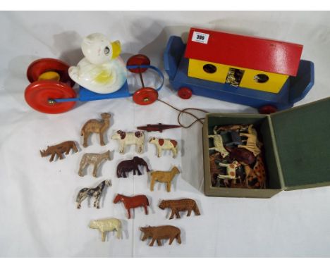 A wooden, wheeled Noah's Ark with animals, a child's pull along duck toy and 30 vintage wooden animals in a box.