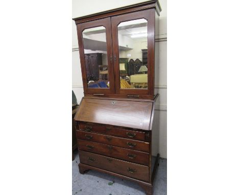 Mid 18th Century mahogany bureau bookcase, the moulded cornice above a pair of mirrored doors with candle slides, the base wi