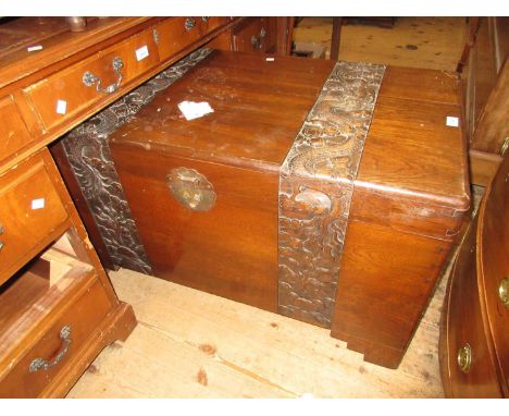 Mid 20th Century oriental carved camphor wood trunk with hinged lid, 39.5ins wideSplit to top, sticky residue as shown in pho