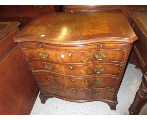 Reproduction mahogany serpentine fronted chest of four long graduated drawers with brushing slide and pierced brass handles o