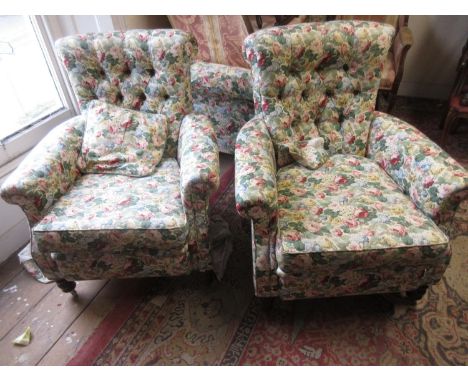 Late Victorian button upholstered two seat chesterfield sofa together with a pair of matching armchairs covered in a floral f