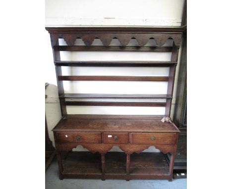 Small George III oak dresser, the shelf back above a moulded top, three drawers, shaped frieze, square cut moulded front supp