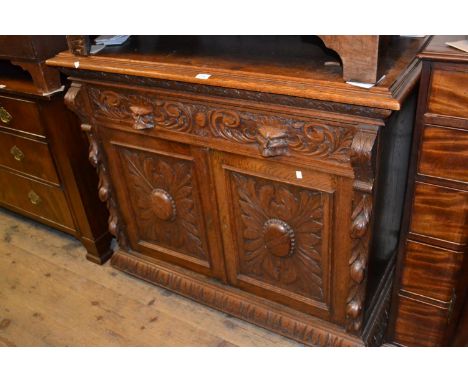 Victorian carved oak buffet with a single drawer above two panel doors 