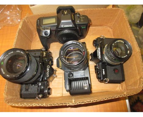 Olympus OM4 camera body with Zuiko 50mm lens, together with three Canon cameras, A1, T70 and EOSOlympus shutter not currently