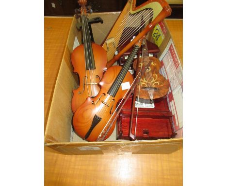 Group of four modern musical boxes in the form of a cello, violin ,harp and a guitar 