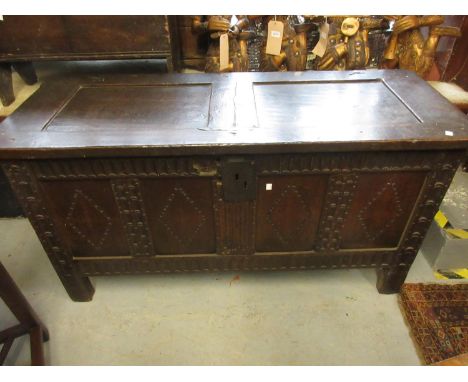 17th Century oak coffer, the hinged two panel lid above a carved four panel front (damages and alterations), 52.5ins wide 