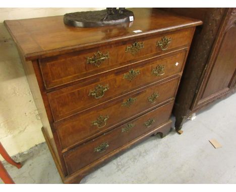 18th Century walnut chest, the quarter veneered crossbanded and herringbone inlaid top above four graduated cock beaded drawe