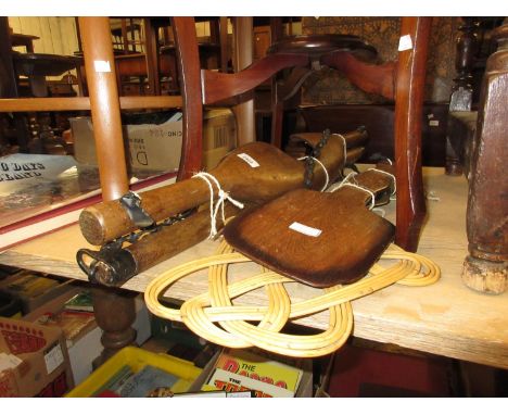 Two antique wooden yolks together with a quantity of other small wooden tools 