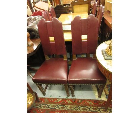 Set of six red leather upholstered dining chairs having shaped upholstered backs and overstuffed seats, on bobbin turned tape
